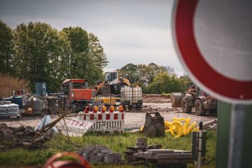there is a large excavator and containers on a large building site