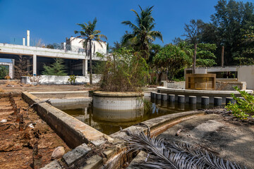 Beautiful abandoned hotel on the beach. Swimming pool in an abandoned hotel. Water in the pool. Sunny day.