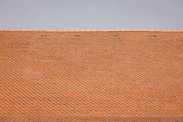 Roof on top and blue sky white cloud background. Pattern of roof. tile top protection. Roof with tiles usable as texture or background.