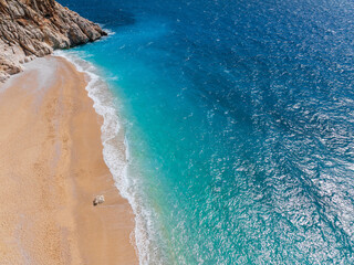 A beautiful view of Kaputaş Beach in Kaş, Kalkan, Antalya, Turkey, highlighting the vibrant turquoise waters and golden sand of this Mediterranean gem.