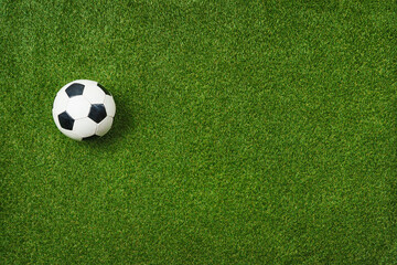  Closeup of soccer ball on textured green grass - center, midfield