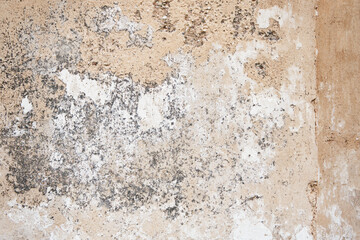 Cracked concrete wall covered with gray cement surface. Grey old wall with shabby damaged plaster...