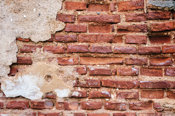 Old brick red wall,brickwork from an old brick in rustic style. Structure and pattern of destroyed stone grunge wall.  Retro style background. Copy space.