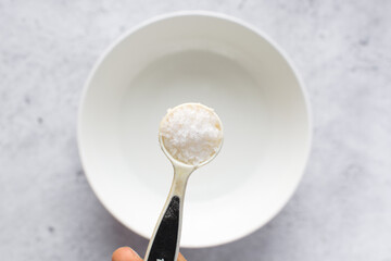 Overhead view of maldon salt in a teaspoon, a teaspoon of sea salt