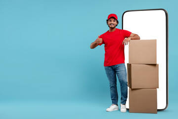 Courier with stack of parcels near huge smartphone on light blue background. Delivery service....