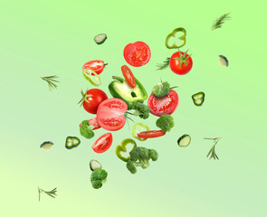Different fresh vegetables in air on green gradient background