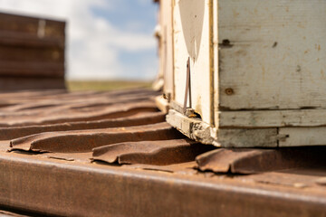 A rusty metal box with a hole in the top. The roof is old and rusted