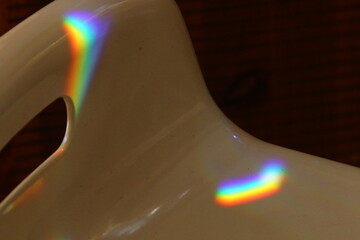 A multi-colored sunbeam is reflected on the tiles.