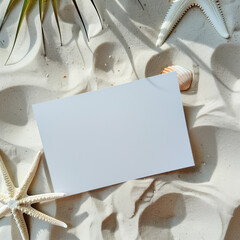 Blank paper on the sandy beach with seashells and starfish.