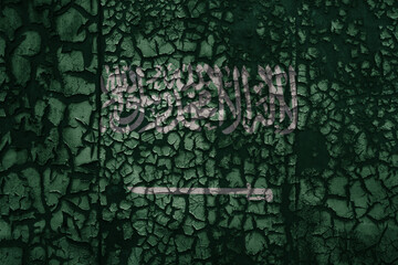 flag of saudi arabia on a old grunge metal rusty cracked wall background