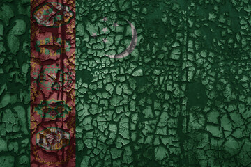 flag of turkmenistan on a old grunge metal rusty cracked wall background