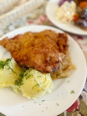 large pork chop, breading on the cutlet, mashed potatoes, lunch dish, typical Polish dinner, potato pancakes with goulash, salads, dinner in a restaurant