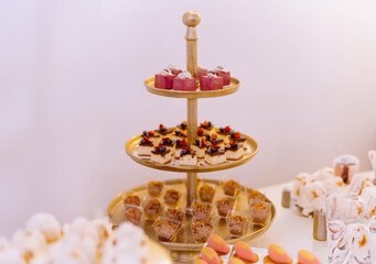 sweet cakes on a glass stand, catering service cakes and pastryes