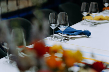 Table setting with dishes, blue tablecloth. Mediterranean style. blue banquet table