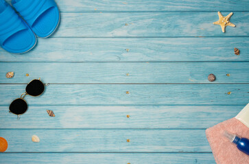 Beach accessories with sea shells on a blue wooden background. Top view, copy space