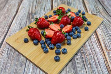 Red ripe strawberry background, close-up, front view, top view, strawberry plate with wood floor background,