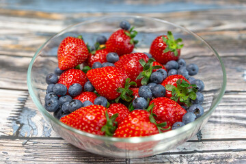 Red ripe strawberry background, close-up, front view, top view, strawberry plate with wood floor background,