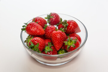 Red ripe strawberry background, close-up, front view, top view, strawberry plate with white background,
