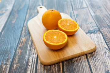 fresh orange isolated on wood table background, close-up, front view, top view,