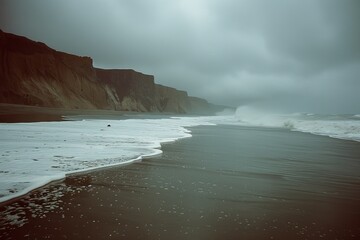 Obraz premium Large Body of Water Next to Sandy Beach