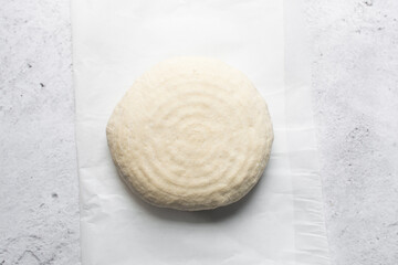 Overhead view of sourdough bread dough about to be baked, artisan bread dough on parchment lined...
