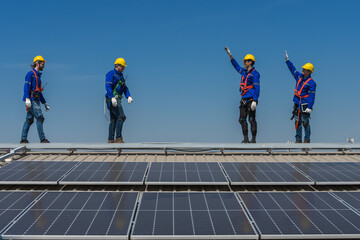 Expertise solar engineer men standing on factory roof after finished install panels on the roof