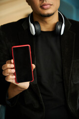 Close up picture of calm guy showing smartphone screen