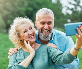 woman man outdoor mature couple selfie together camera photo phone smartphone mobile mid adult cell smiling love old lifestyle wife happiness middle aged nature active vitality