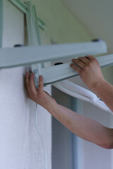 Installing a hanger for the air conditioner compressor.