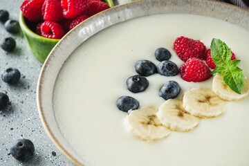 sweet semolina with berries on a light stone background