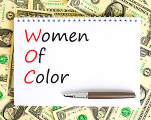 WOC women of color symbol. Concept words WOC women of color on beautiful white note. Dollar bills. Beautiful dollar bills background. Business WOC women of color social issues concept. Copy space. - obrazy, fototapety, plakaty