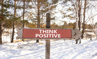 Think positive symbol. Concept words Think positive on beautiful wooden road sign. Beautiful forest...