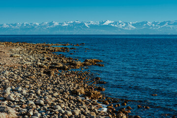 Rocky shore of Issyk-kul lake in Kyrgyzstan in spring