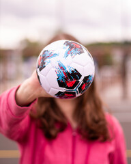 Mini football in girl's hand