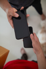 SME business operator is inspecting and packing products into parcel box for delivery company that will come pick up products after participating in online marketing with Application shopping online