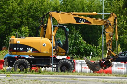 Kielce, Świętokrzyskie, Poland - 2022-06-23 - Excavator on the road Caterpillar M313C CAT