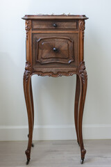 Antique wooden cabinet with finely sculpted curved long legs and granite table top