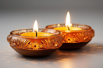 Two Diwali diya (Indian oil lamp) on white background. Indian Light Festival. Holiday design