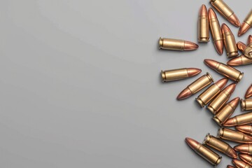 A pile of bullet casings on a gray surface. Suitable for military and crime-related themes