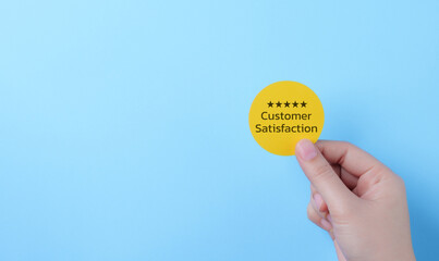 Customer review satisfaction feedback survey concept. Hand holding five-star customer satisfaction...