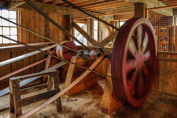 Drive belts and wooden pulleys driving an old water-powered sawmill.
