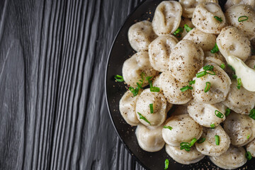 fresh cooked dumplings on a black wooden rustic background