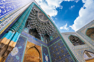 Stunning Persian-Islamic architecture with minarets and intricate tiles in vibrant blue tones. Imam...