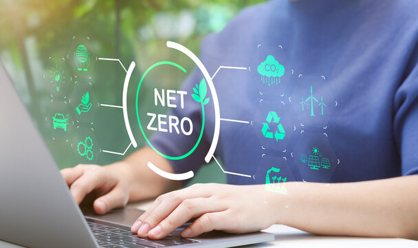 Woman use laptop with environmental carbon reduction icon or net zero technology. carbon neutrality. Carbon footprint, CO2 emissions, Sustainable energy, Global warming, Greenhouse gas, Climate change