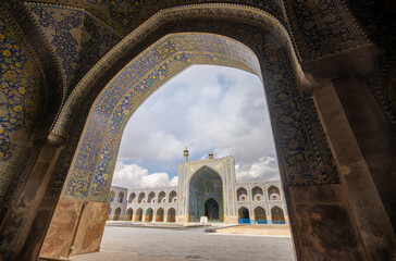 Stunning Persian-Islamic architecture with minarets and intricate tiles in vibrant blue tones. Imam Mosque, Naqsh-e Jahan Square, Isfahan, Iran.