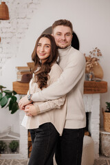 Happy young couple in love is hugging gentle and smiling together celebrating Valentine's day at...