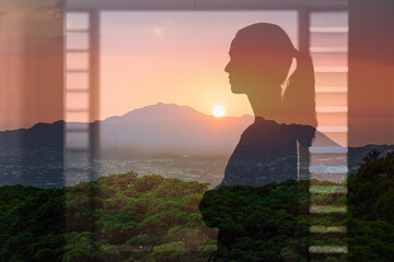 thoughtful young woman looking out her bedroom window at the beautiful sunrise, people in a calm happy state of mind 