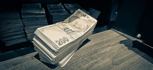 Bales of Turkish Lira banknotes in the bank in front of the cash register