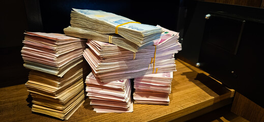 Bales of Turkish Lira banknotes in the bank in front of the cash register