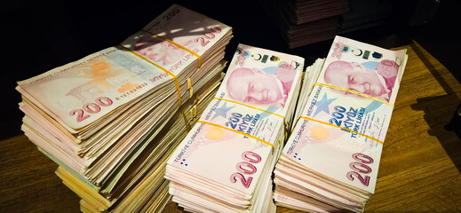 Bales of Turkish Lira banknotes in the bank in front of the cash register